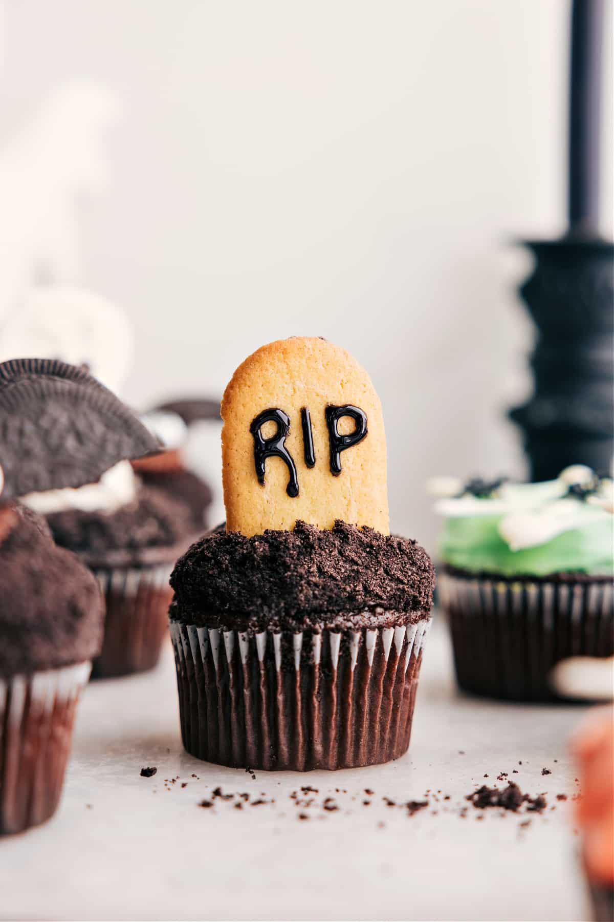 Tombstone Themed Halloween Cupcakes Tombstone treat with Milano cookies and black frosting.