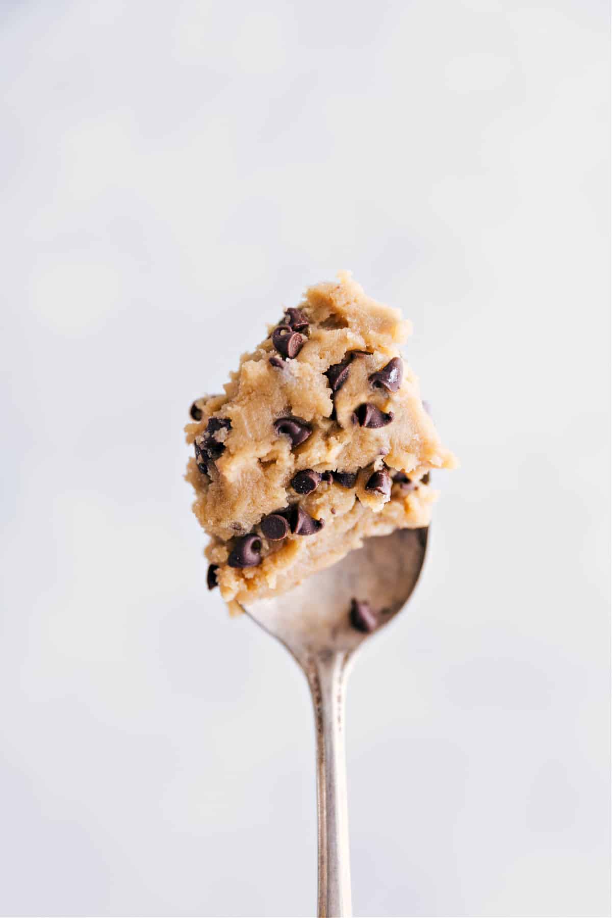 Favorite Edible Cookie Dough Recipe A spoonful of the edible cookie dough being held up.