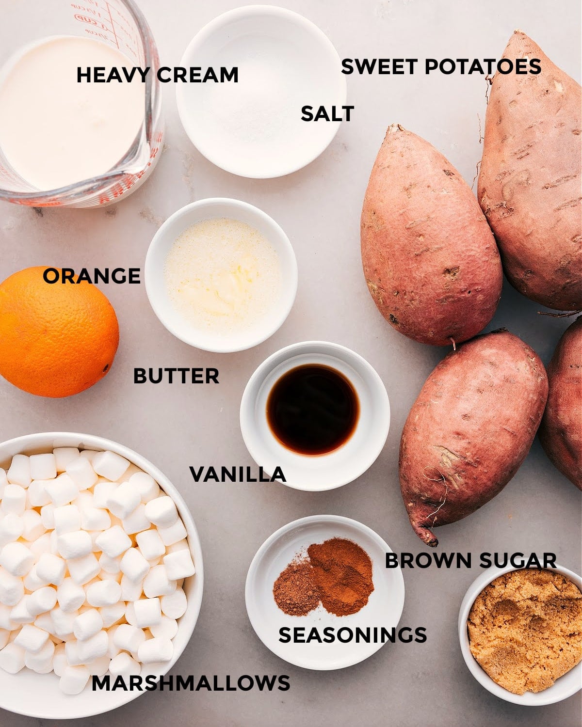 Ingredients In Sweet Potato Casserole All the ingredients in this recipe prepped out for easy assembly including the heavy cream, salt, potatoes, orange, butter, vanilla, seasonings, brown sugar and marshmallows.