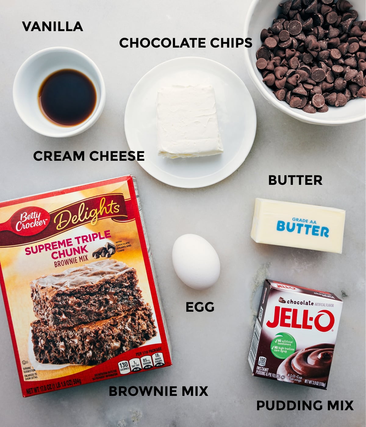 Ingredients In Brownie Cookies All the ingredients in this recipe including the box mix, butter, jell-o, butter, egg, chocolate chips, vanilla, and cream cheese prepped out for easy assembly.