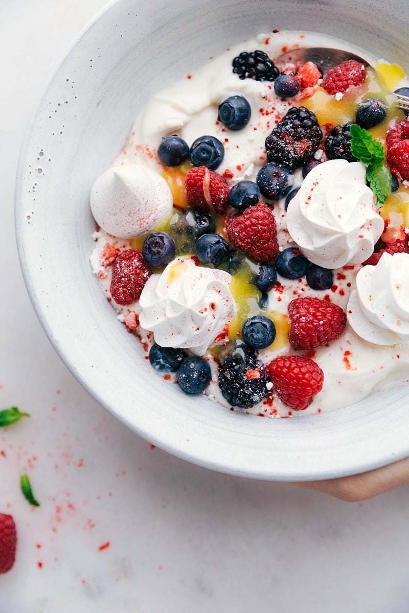 Meringue Cookie Recipe in a bowl with yogurt, berries, and lemon curd.