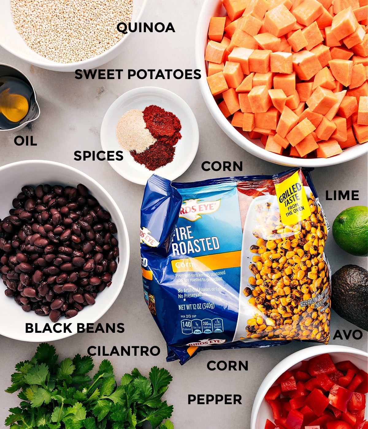 Ingredients In Quinoa Black Bean Salad All the ingredients for this recipe prepped and ready for easy assembly, including beans, corn, grains, veggies, spices, lime, and oil.