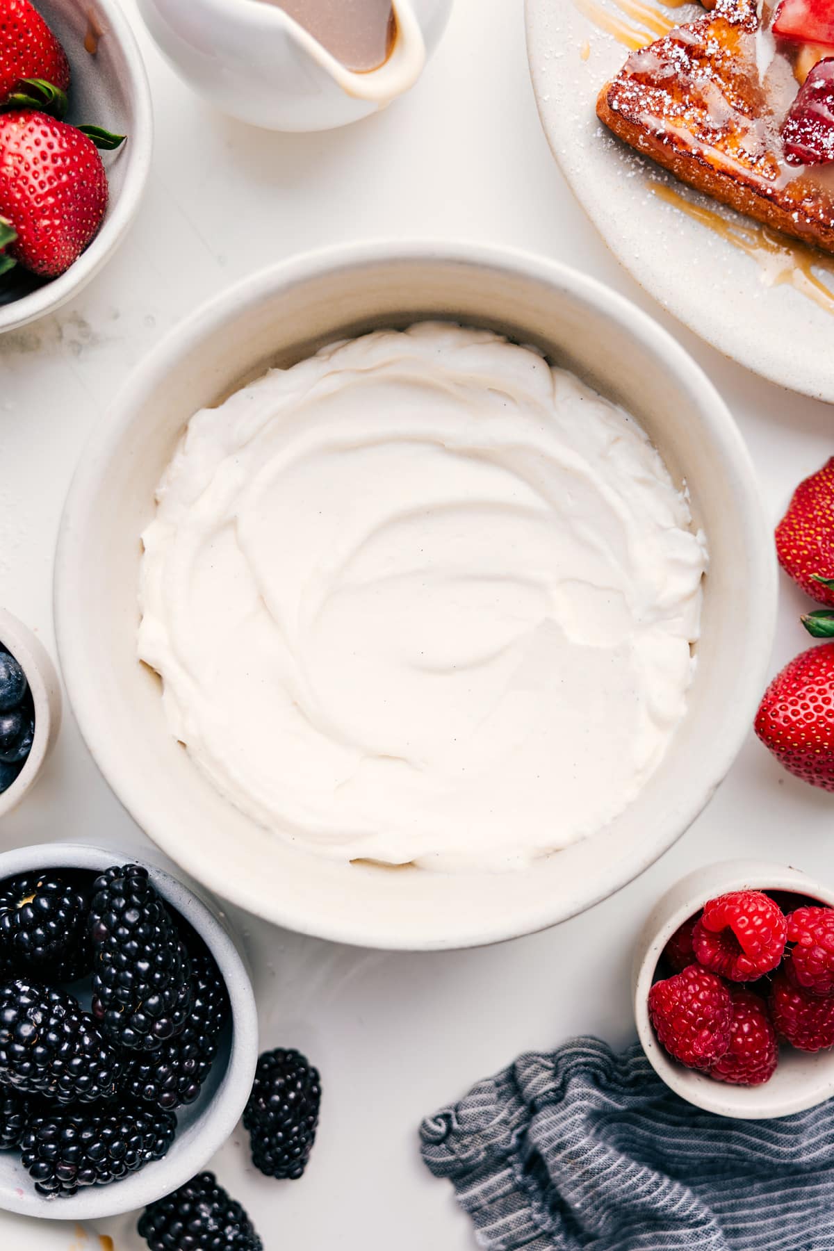 The Whipped Cream Recipe Everyone Needs In Their Back Pocket Whipped Cream Recipe whipped to soft peaks in a mixing bowl, light and fluffy and ready to serve.