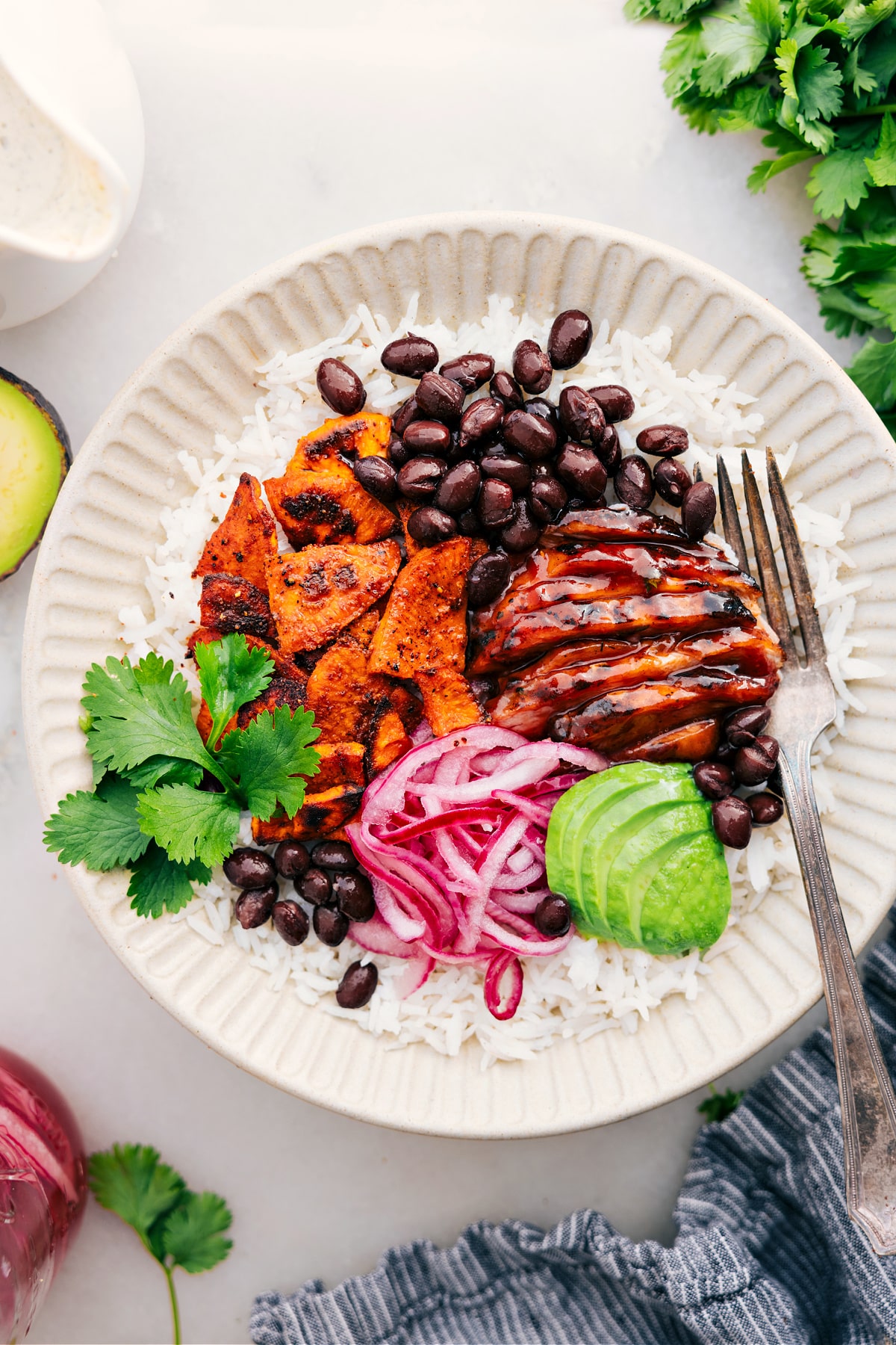 BBQ Chicken Bowls BBQ chicken bowl with black beans, picked red onions, and avocado.