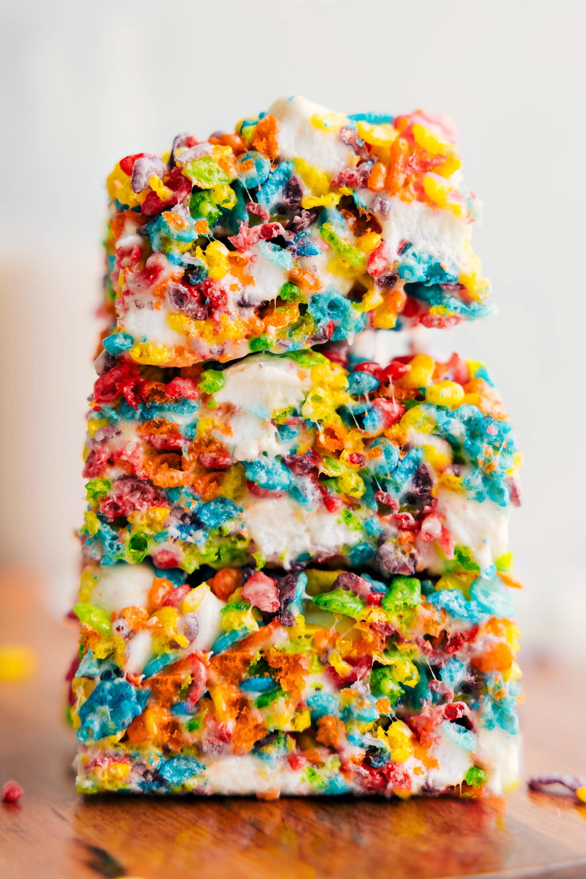 You Won't Be Able To Get Enough Of These Fruity Pebble Rice Krispie Treats The gooey and delicious dessert stacked on top of each other cut into squares ready to be served.