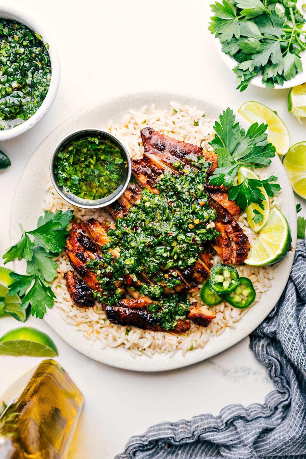 Chimichurri Chicken on a bed of rice, topped with fresh chimichurri sauce and ready to be enjoyed.