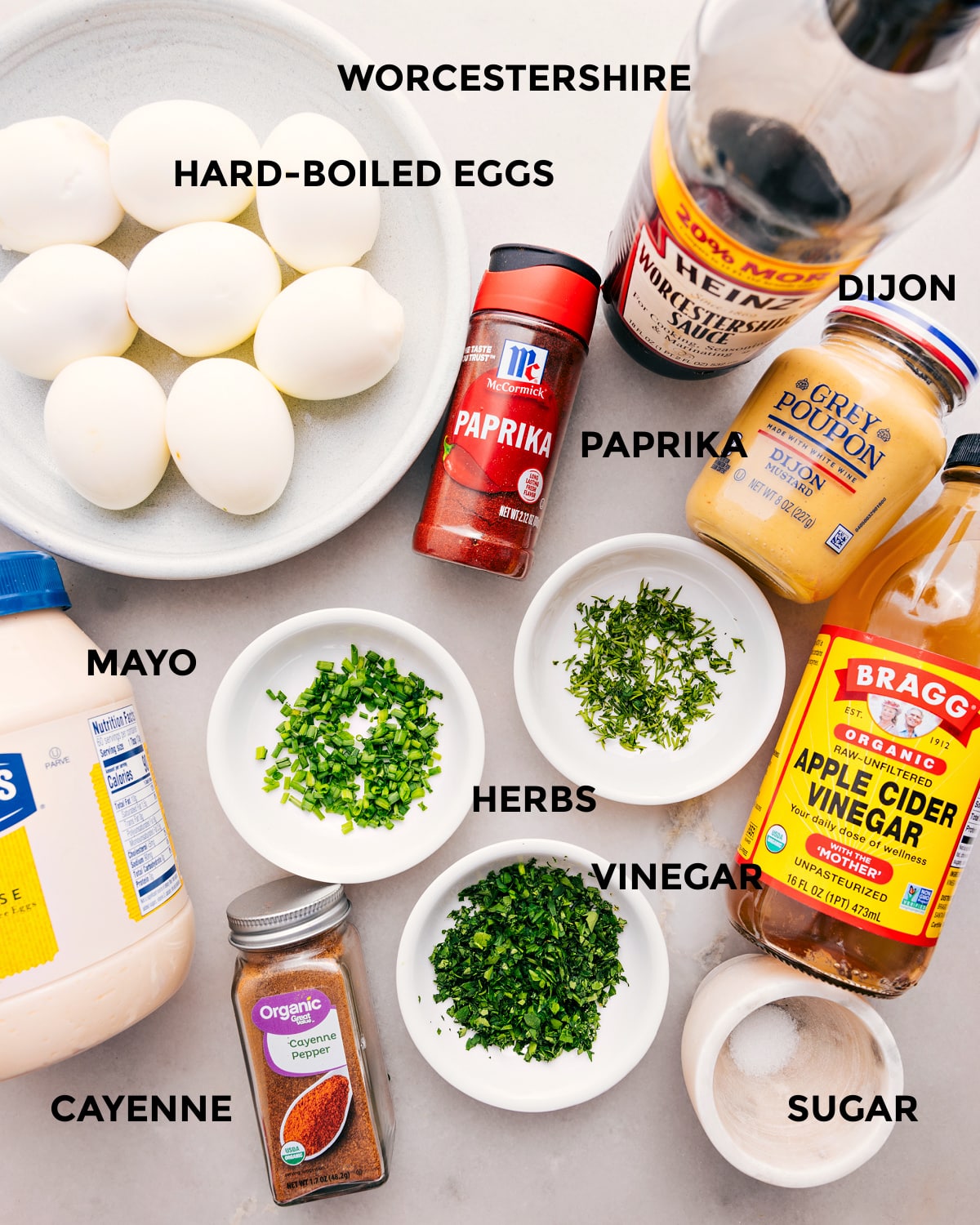 Ingredients In Deviled Eggs All the ingredients for this recipe are prepped and ready for easy assembly: eggs, Dijon, paprika, vinegar, herbs, mayo, seasonings, and sugar.
