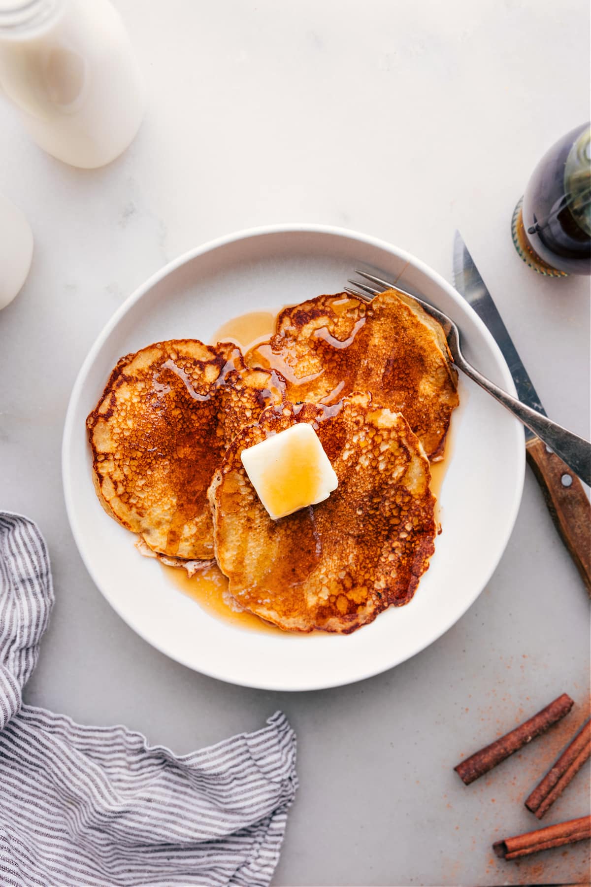 Delicious stack of Old-Fashioned Pancake Recipe drizzled with syrup on plate.
