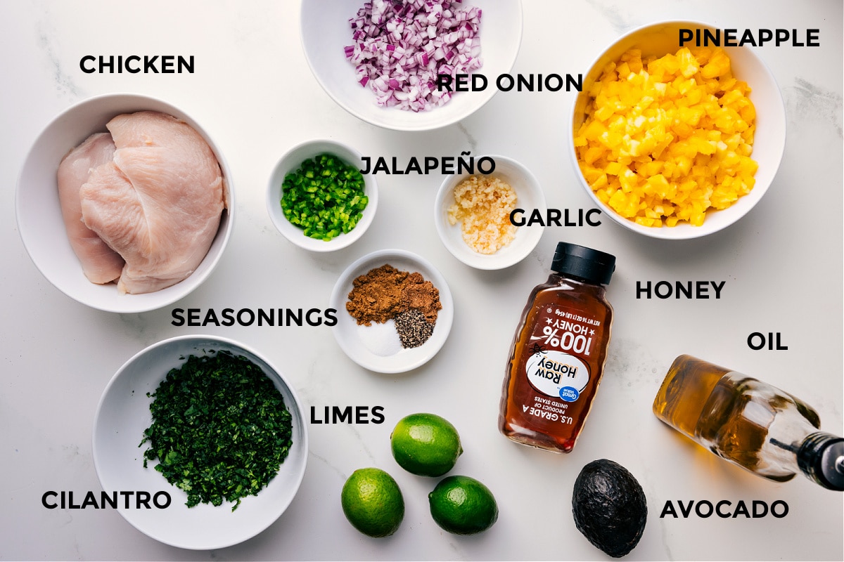 Ingredients In Pineapple Chicken All the ingredients prepped for easy assembly: meat, red onion, pineapple, jalapeño, garlic, honey, oil, avocado, limes, seasonings, and cilantro.