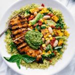 Pesto Chicken with chicken, corn and white bean salsa, and pesto on top.