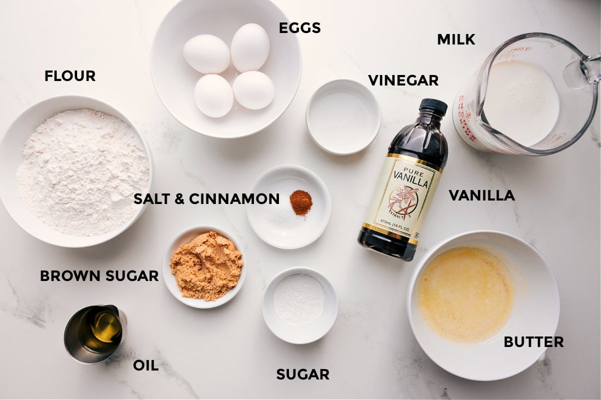 Ingredients In Waffle Recipe All the ingredients in this recipe prepped out for easy assembly including the flour, brown sugar, oil, eggs, salt, cinnamon, vinegar, sugar, vanilla, milk, and butter.