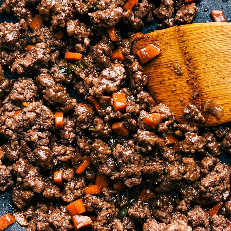 Cooked ground beef with carrots used in Asian-style beef lettuce wraps, ready to be wrapped in lettuce leaves.