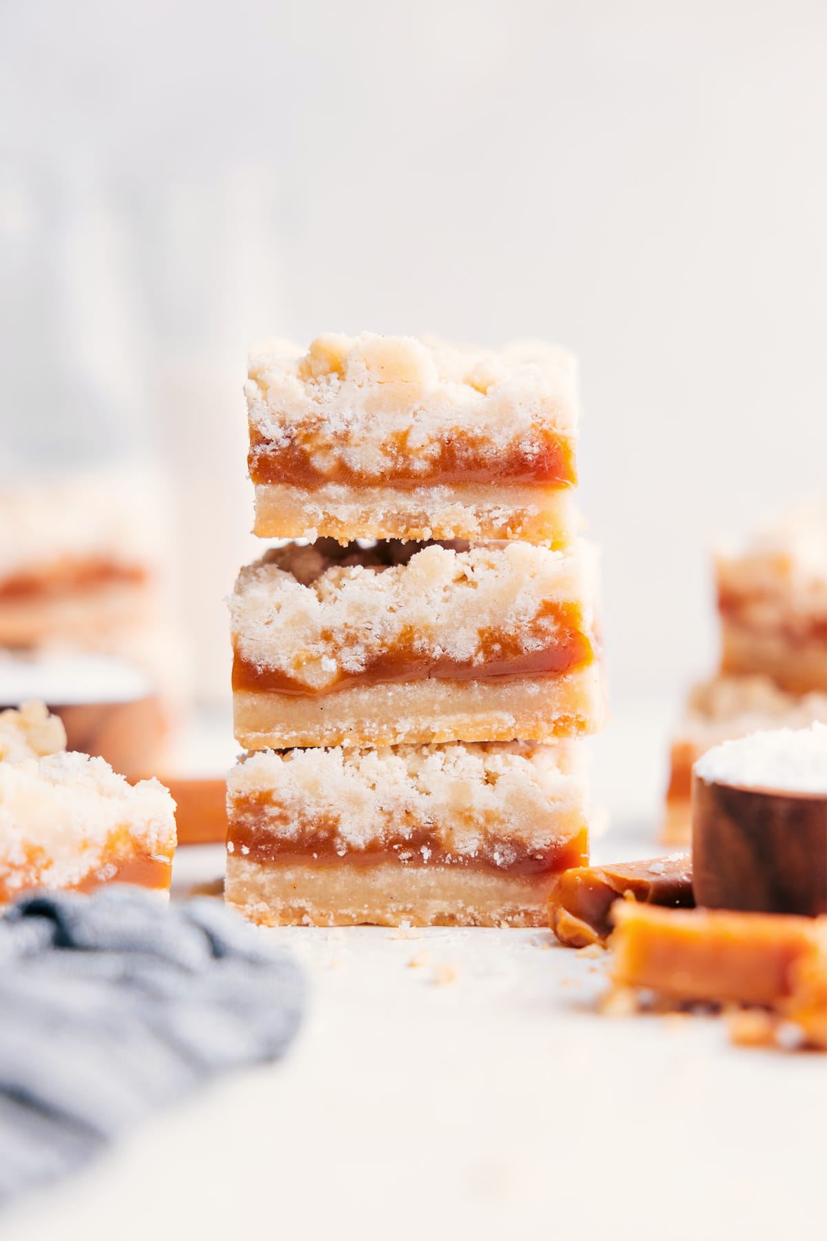 Caramel cookie bars stacked in layers on top of each other.