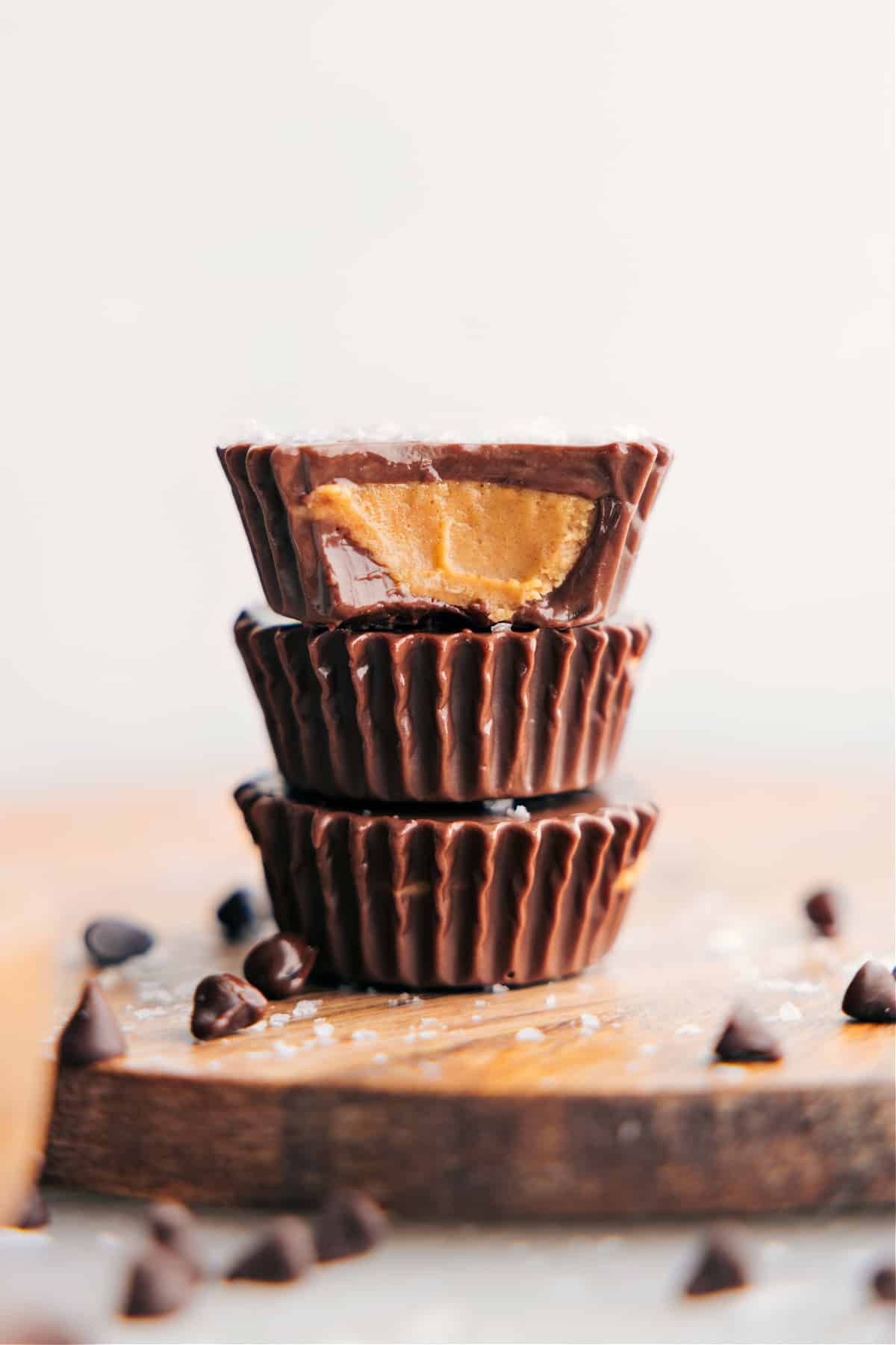 The Best Homemade Peanut Butter Cups Recipe Homemade Peanut Butter Cups stacked on top of each other with a bite out of one of them showing the delicious inside.