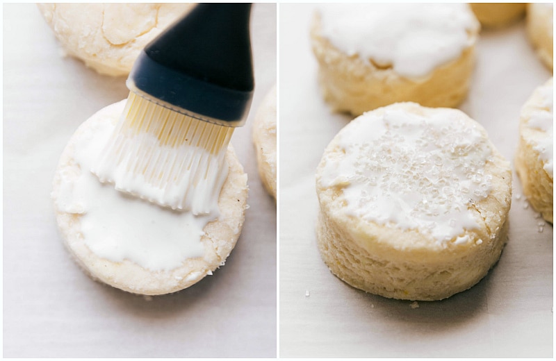 Adding Cream and Sugar to Biscuits Before Baking Heavy cream and coarse sugar being brushed and sprinkled on the tops of the biscuits before baking, enhancing their golden color and texture.