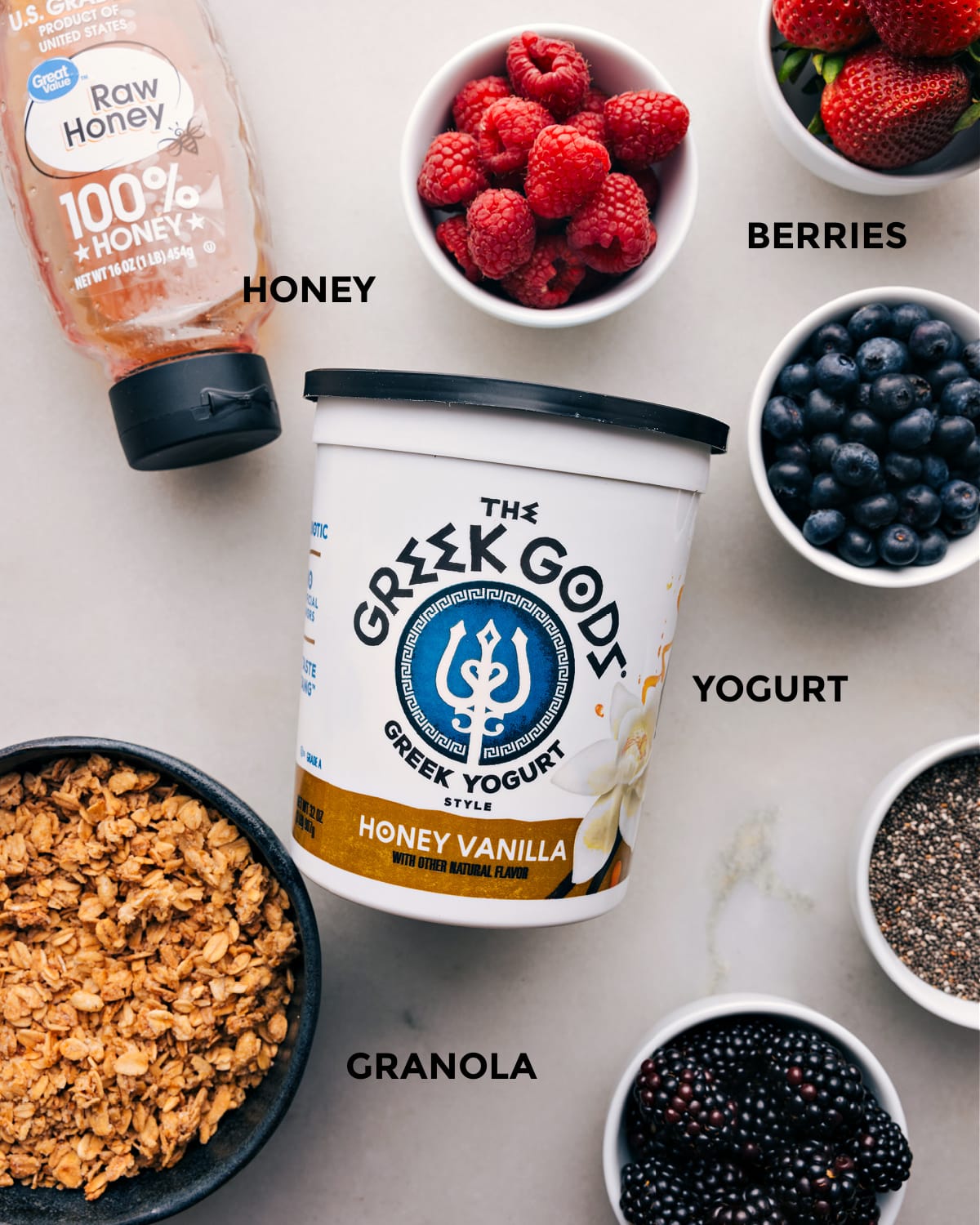 Prepped Ingredients for Yogurt Parfait All the ingredients for the recipe prepped and laid out for easy assembly, including fresh fruit, honey, and granola.