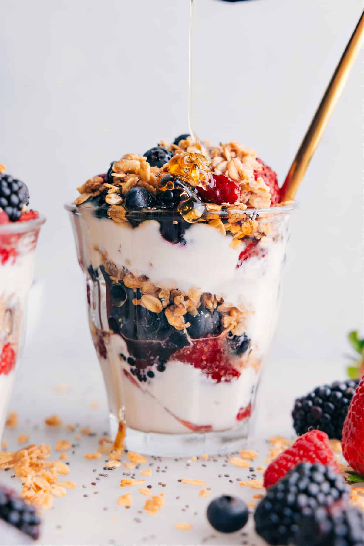 Drizzling Honey on Yogurt Parfait Yogurt parfait with a drizzle of honey being added on top, enhancing the sweetness and flavor.