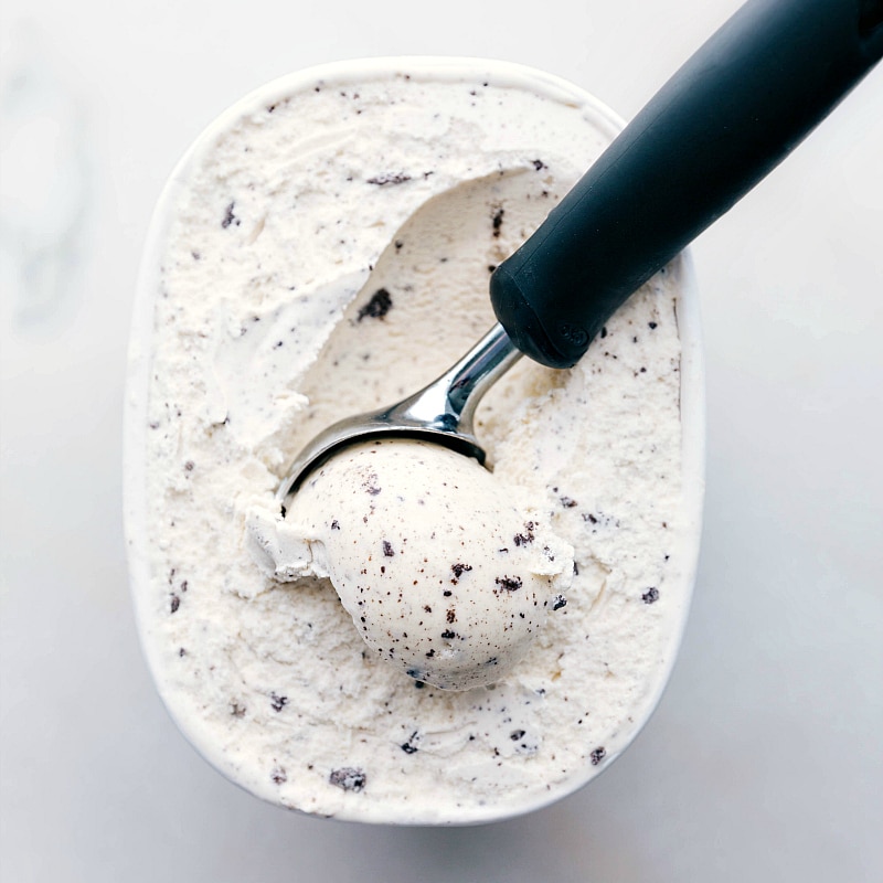 Scooping Cookies and Cream Ice Cream A container of cookies and cream ice cream with a scoop in it, ready to be added to the recipe.