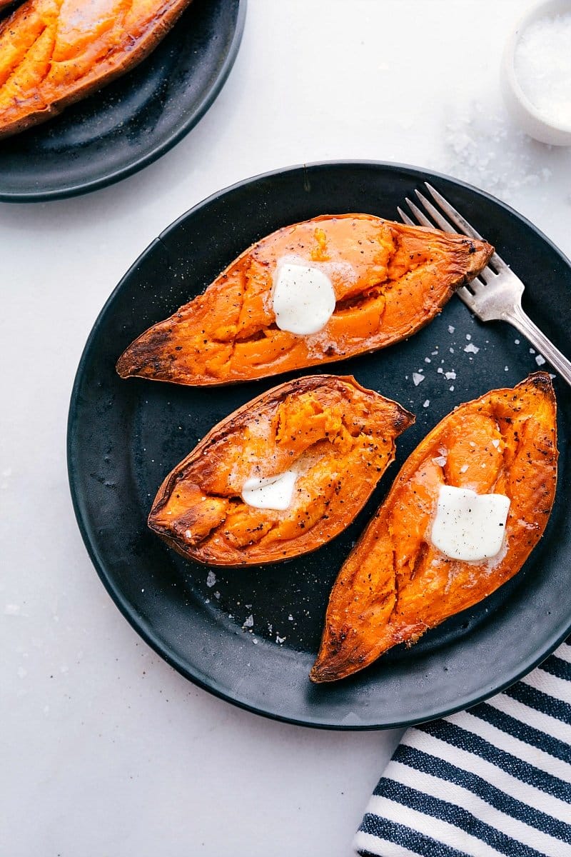 Delicious Baked Sweet Potatoes Recipe Baked sweet potatoes on a plate with melting butter on top.