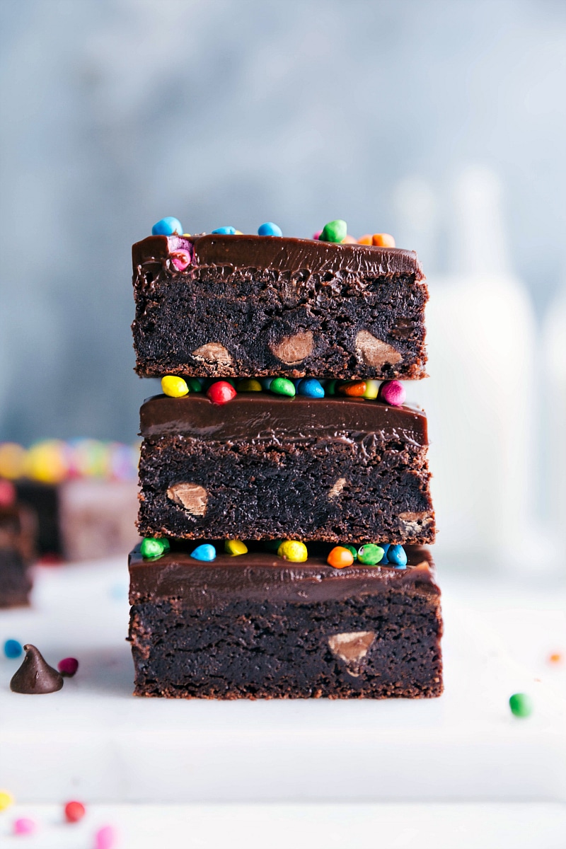 Nostalgic Cosmic Brownies - Stacked and Topped with Colorful Candies Homemade cosmic brownies stacked, showcasing its delicious layers, and topped with colorful candies - a nostalgic and delicious treat.