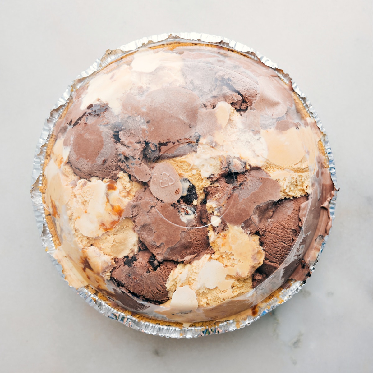 How To Make Ice Cream Pie The dessert completed and covered with the plastic lid and put in the freezer to harden.