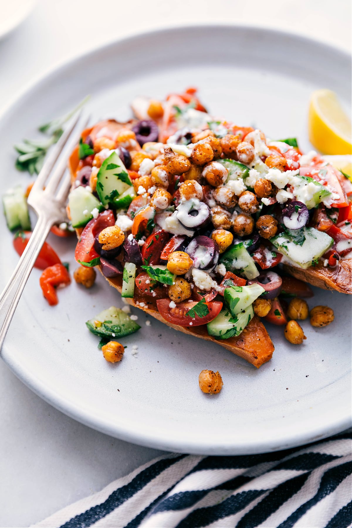 Mediterranean Baked Sweet Potatoes with Vibrant Vegetable Topping and Lemon Dressing