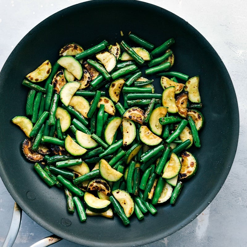 Cooking Mastery: Perfectly Prepared Zucchini and Green Beans in a Saucepan Zucchini and green beans cooked to perfection in a saucepan, tender and flavorful.