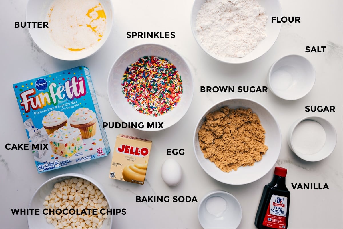 Ingredients In Cake Batter Cookies All the ingredients for this recipe prepped and ready for easy assembly, including butter, cake mix, sprinkles, pudding mix, flour, salt, sugar, brown sugar, vanilla, baking soda, and white chocolate chips.