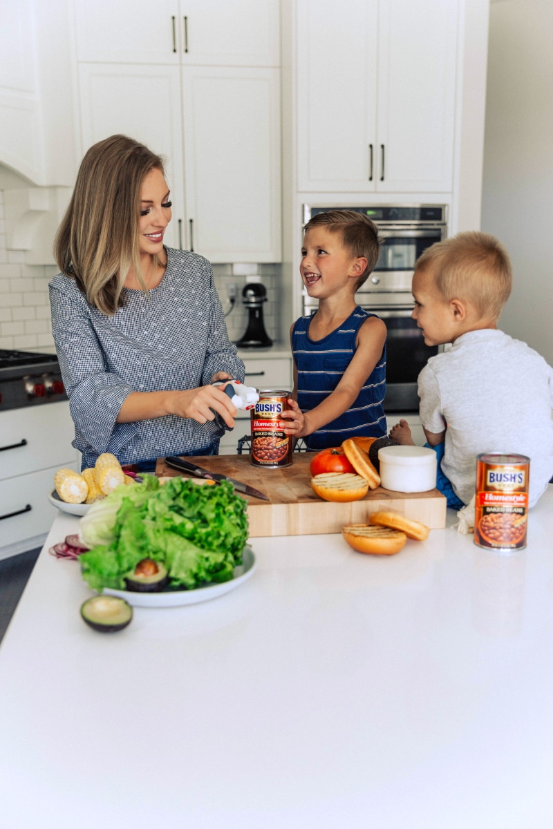 Chelsea and Her Sons Opening a Can of Baked Beans helsea alongside her boys, opening a can of baked beans, preparing to serve them as a delicious side for their meal.