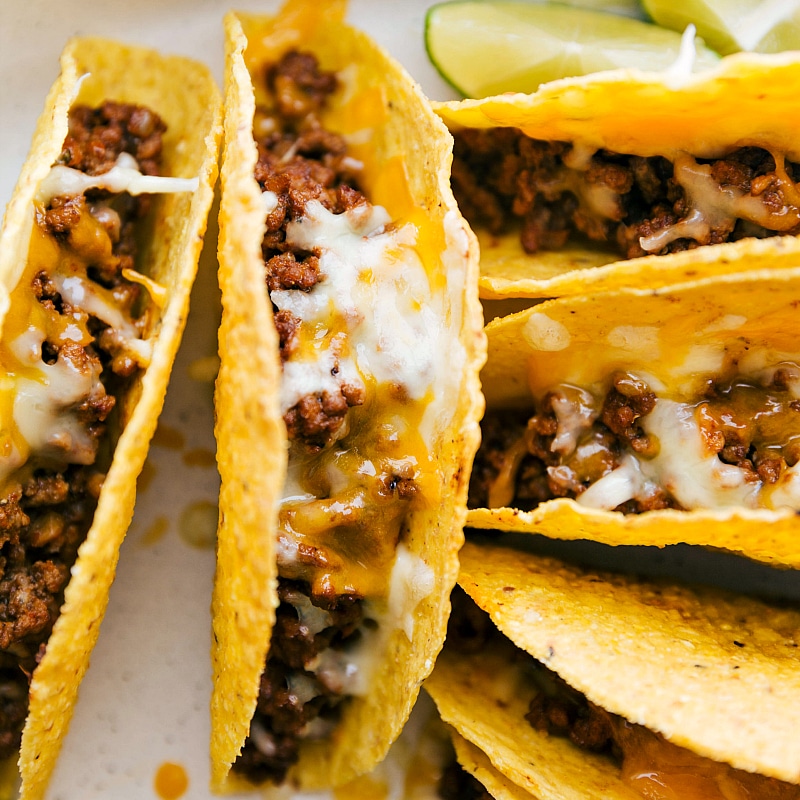 Freshly Baked Ground Beef Tacos - Topped with Melty Cheese Ground beef tacos fresh out of the oven, topped with melty cheese, hot and ready to be served.