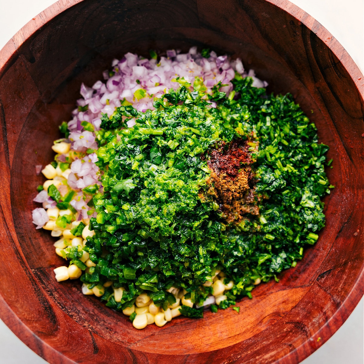 All the corn salsa recipe ingredients piled together in a bowl All the corn salsa recipe ingredients piled together in a bowl