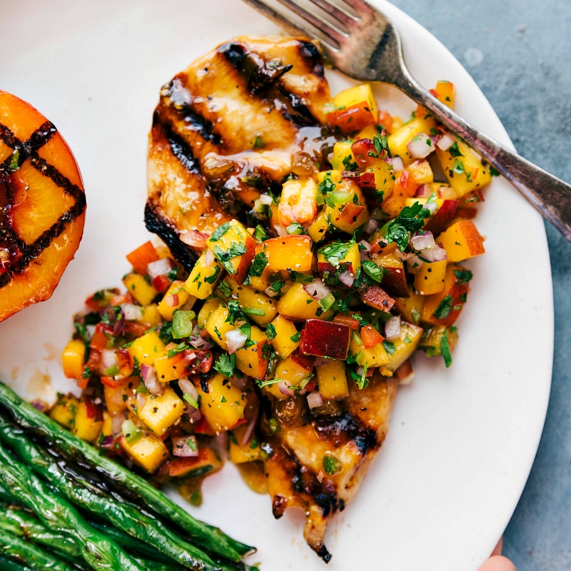 Grilled Chicken with Peach Salsa and Green Beans - A Tasty and Colorful Dish Delicious grilled chicken topped with peach salsa, served with green beans on the side.