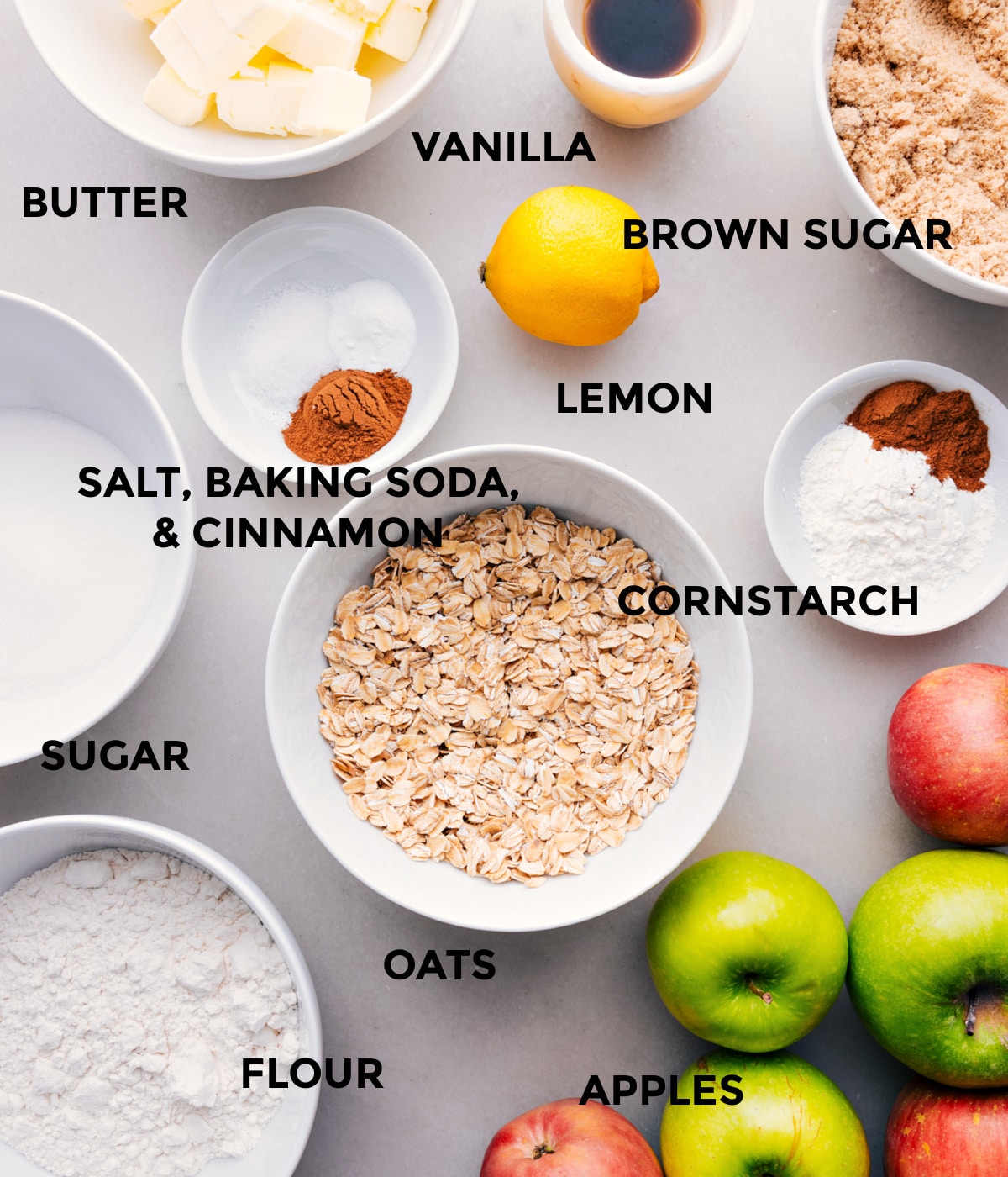 Ingredients for Apple Crumble - Chopped Apples, Sugar, Oats, Spices Dessert ingredients including butter, sugar, oats, and spices.