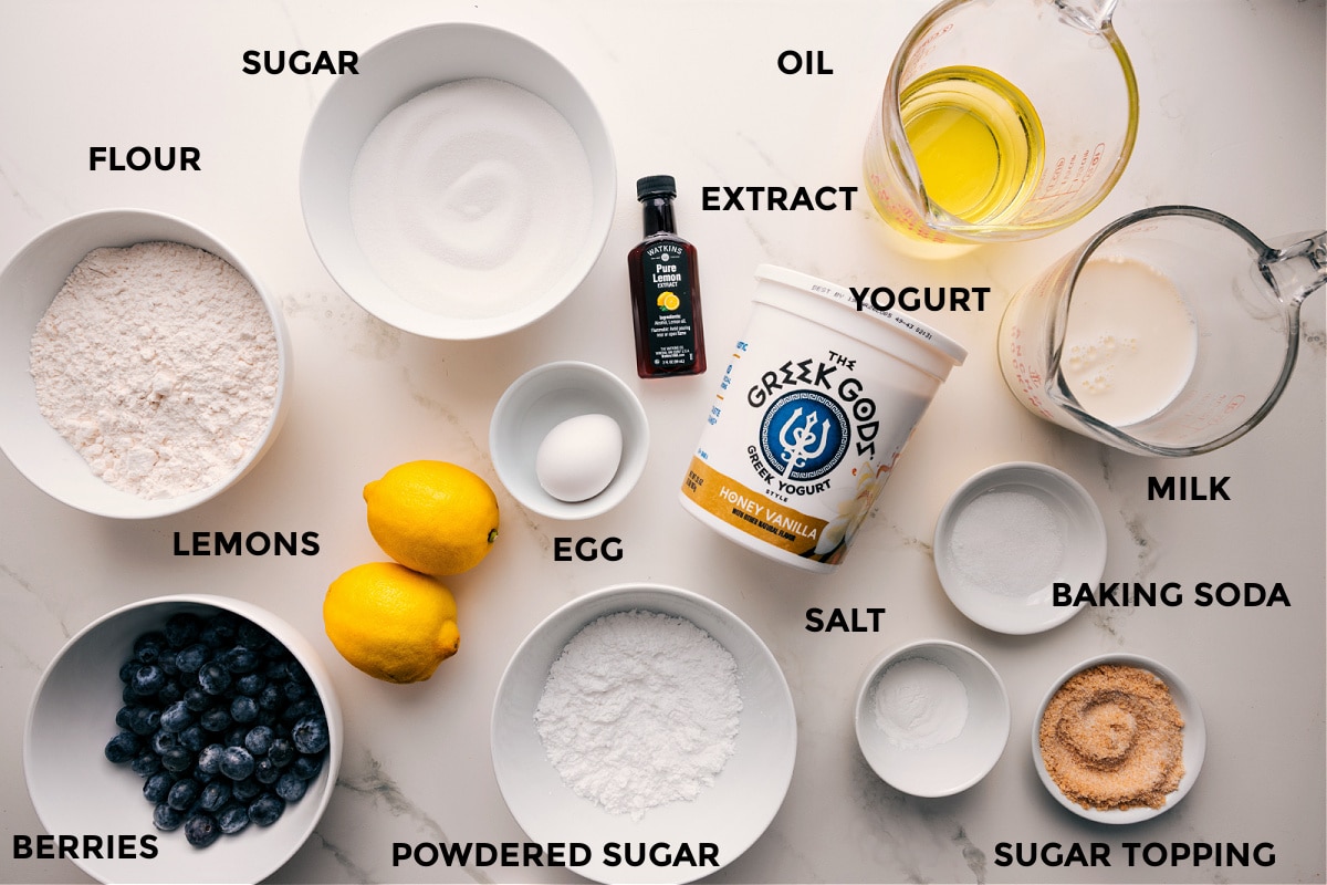 Ingredients In Lemon Blueberry Bread All the ingredients in this recipe prepped out for easy assembly including the flour, berries, lemons, powdered sugar, egg, sugar, extract, oil, milk, baking soda, salt, and yogurt.