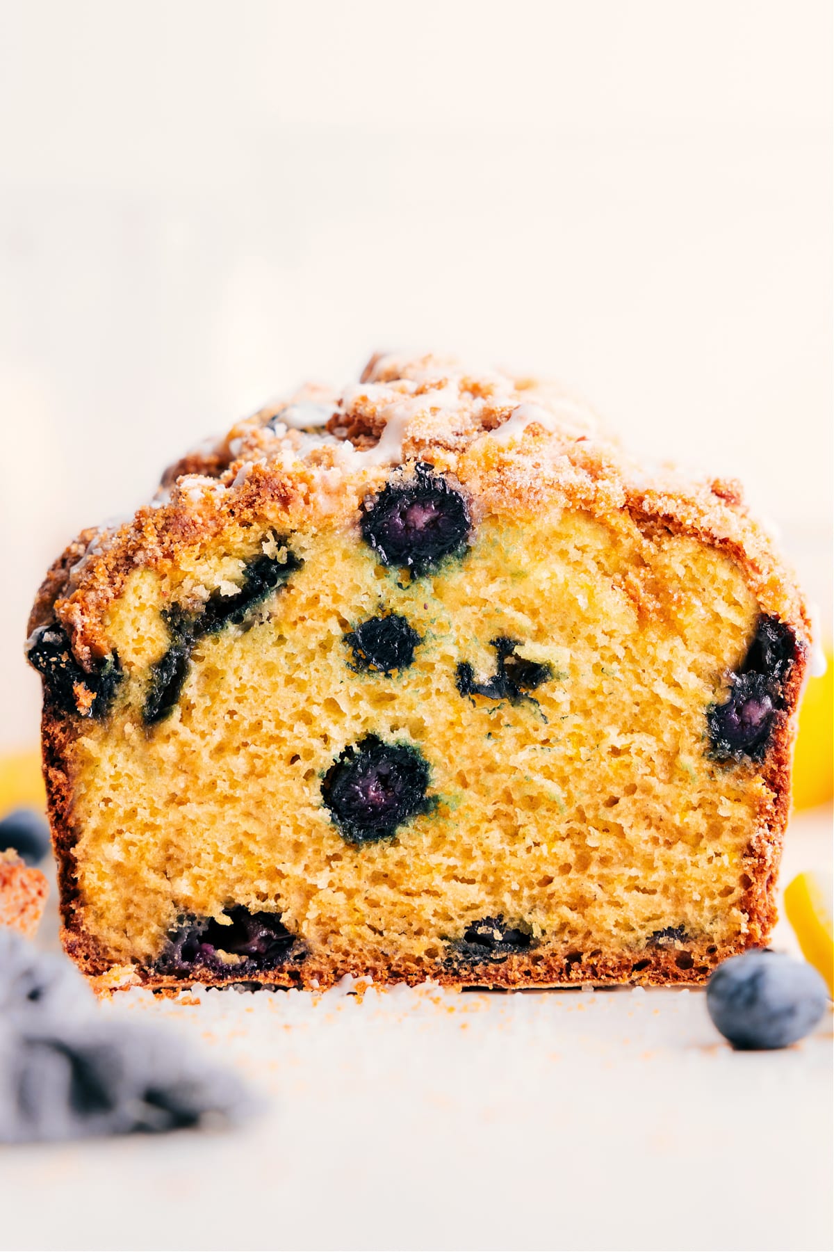 Lemon blueberry bread sliced to show the moist crumb and juicy blueberries.