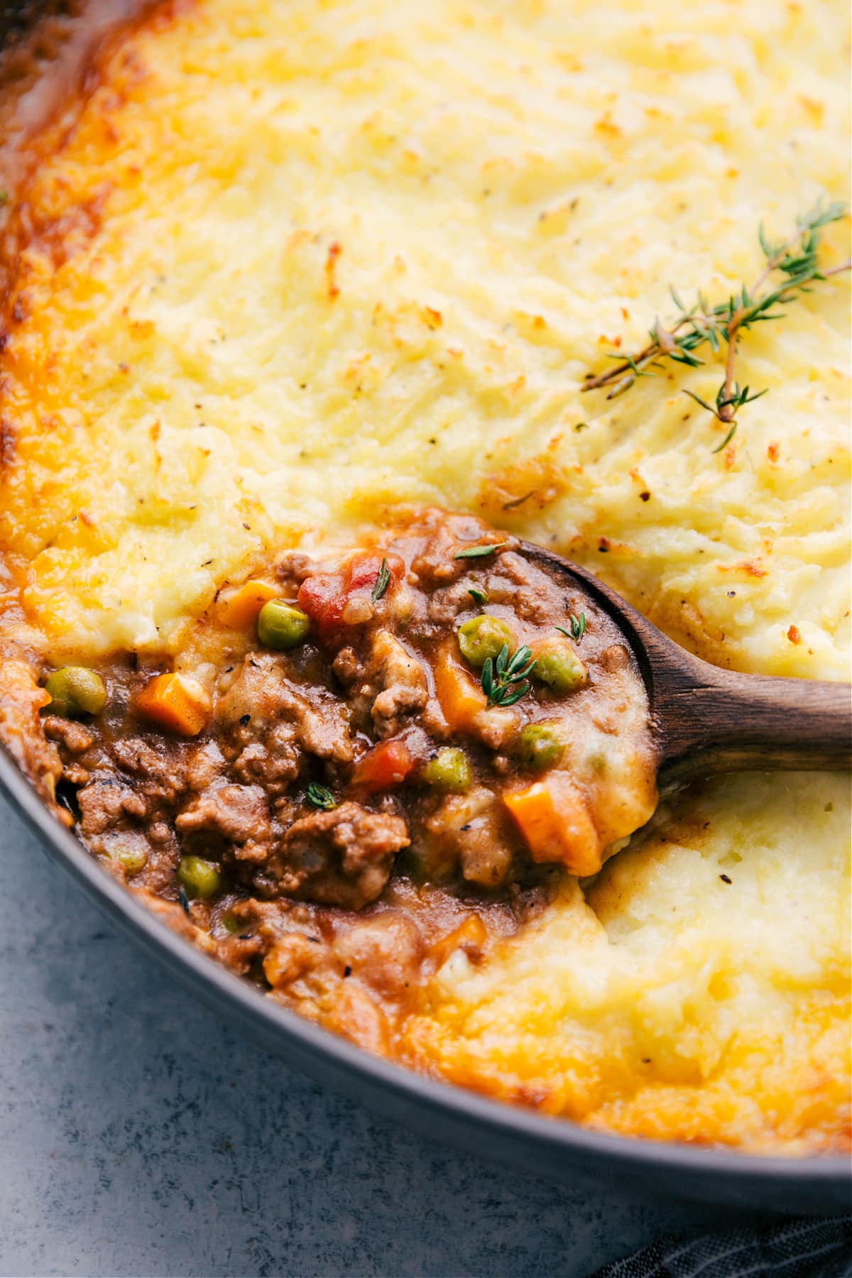 Ground Beef Shepherd's Pie in the skillet with a big scoop coming out.