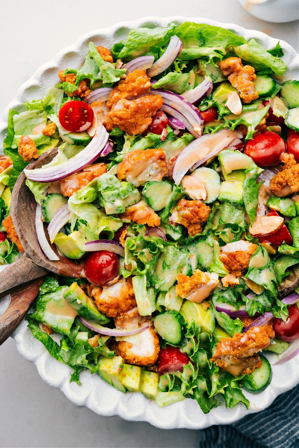 Crispy Chicken Salad drizzled with delicious dressing in a bowl.