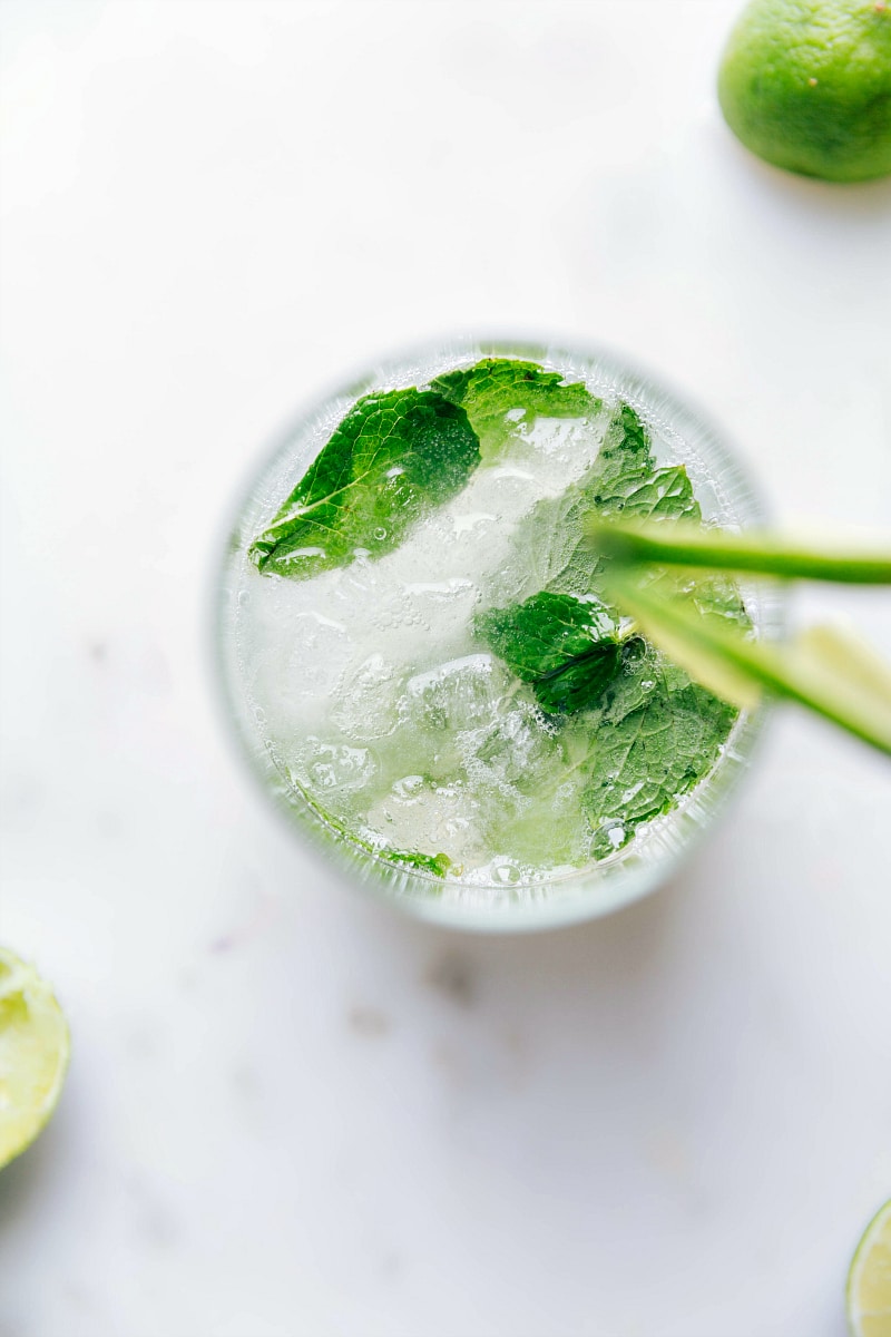 A refreshing virgin mojito topped with fresh mint leaves, served in a tall glass.