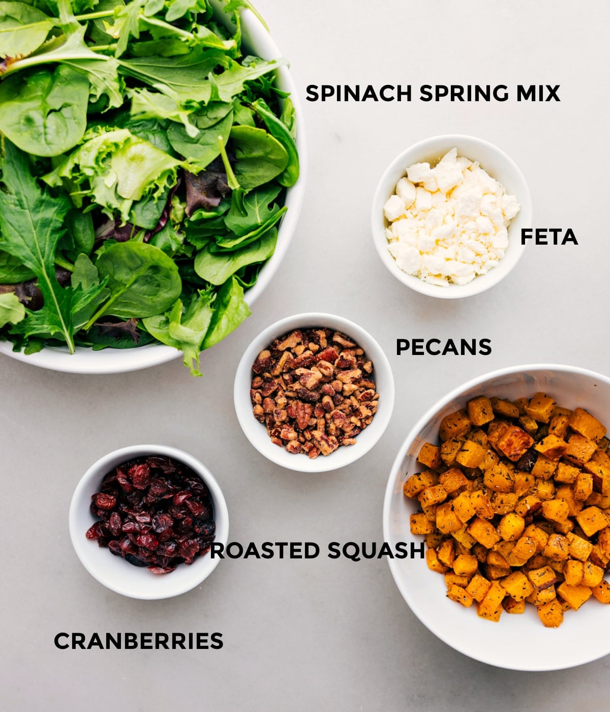 Ingredients In Thanksgiving Salad All the ingredients in this recipe, including the greens, feta, pecans, roasted squash, and cranberries, are prepped for easy assembly.