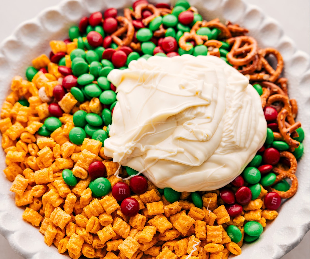 White Chocolate Christmas Snack Mix Pour the white chocolate over the dry ingredients.