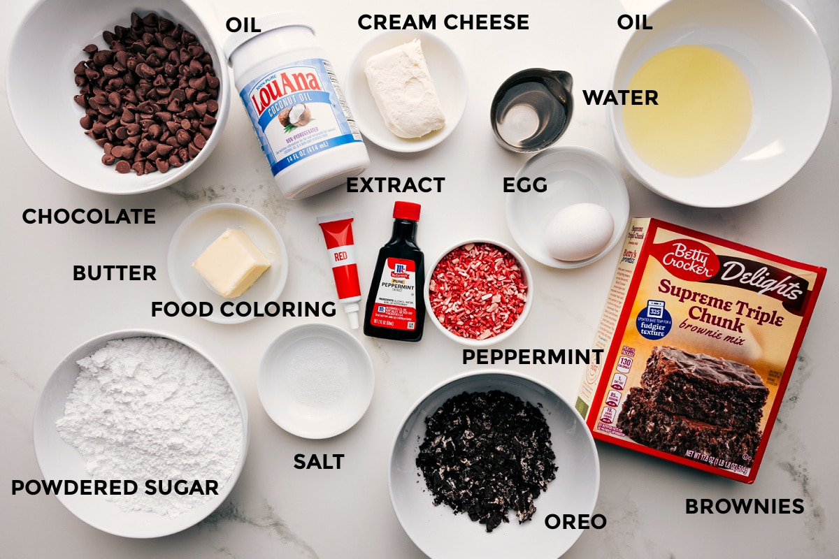 Ingredients In Peppermint Brownies All the ingredients in this recipe prepped out for easy assembly including chocolate, butter, food coloring, salt, powdered sugar, Oreo, cream cheese, peppermint, extract, egg, oil, water, and brownie mix.