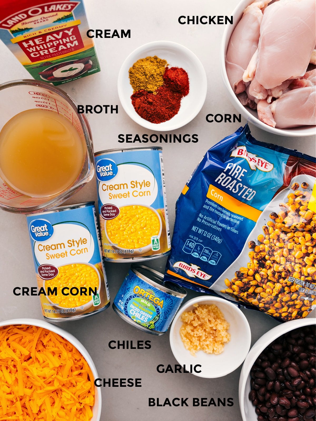 Ingredients In Chicken Corn Chowder All the ingredientsโbroth, seasonings, meat, veggies, black beans, chiles, and cheeseโare prepped for easy assembly.