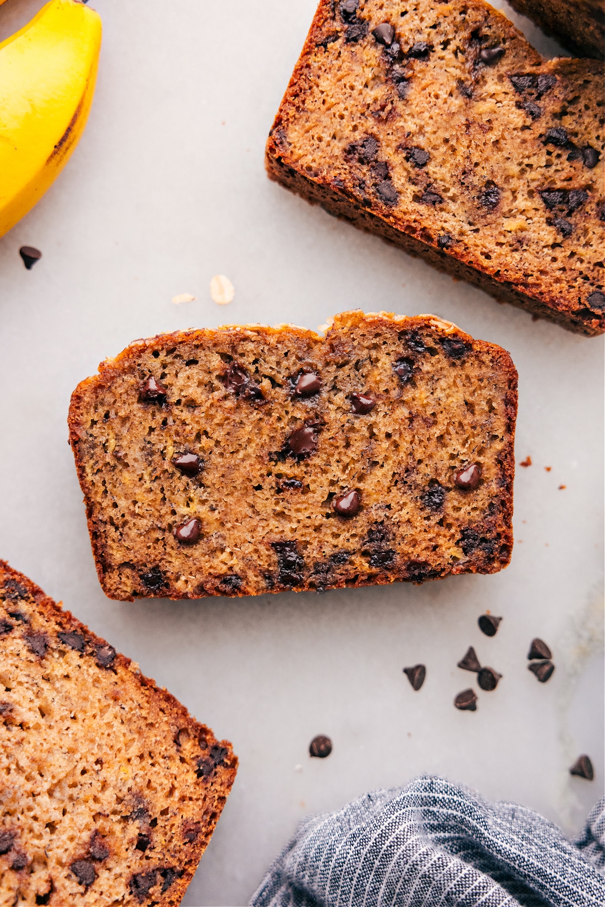 Slices of Healthy Banana Bread Recipe, warm and inviting, with chocolate chips scattered throughout.