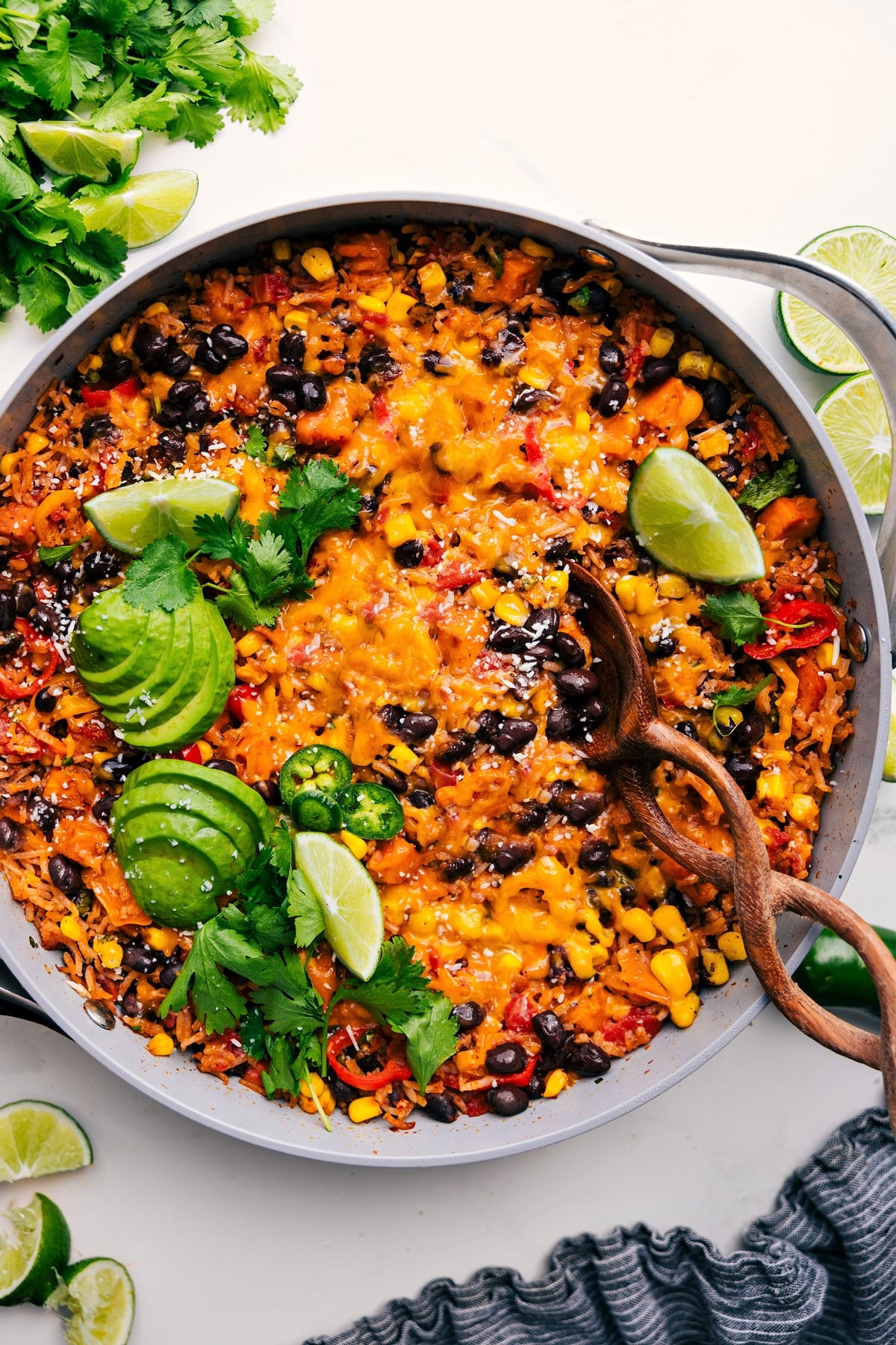 One Skillet Sweet Potato Burrito Bowls topped with fresh cilantro, jalapeños, and avocado.