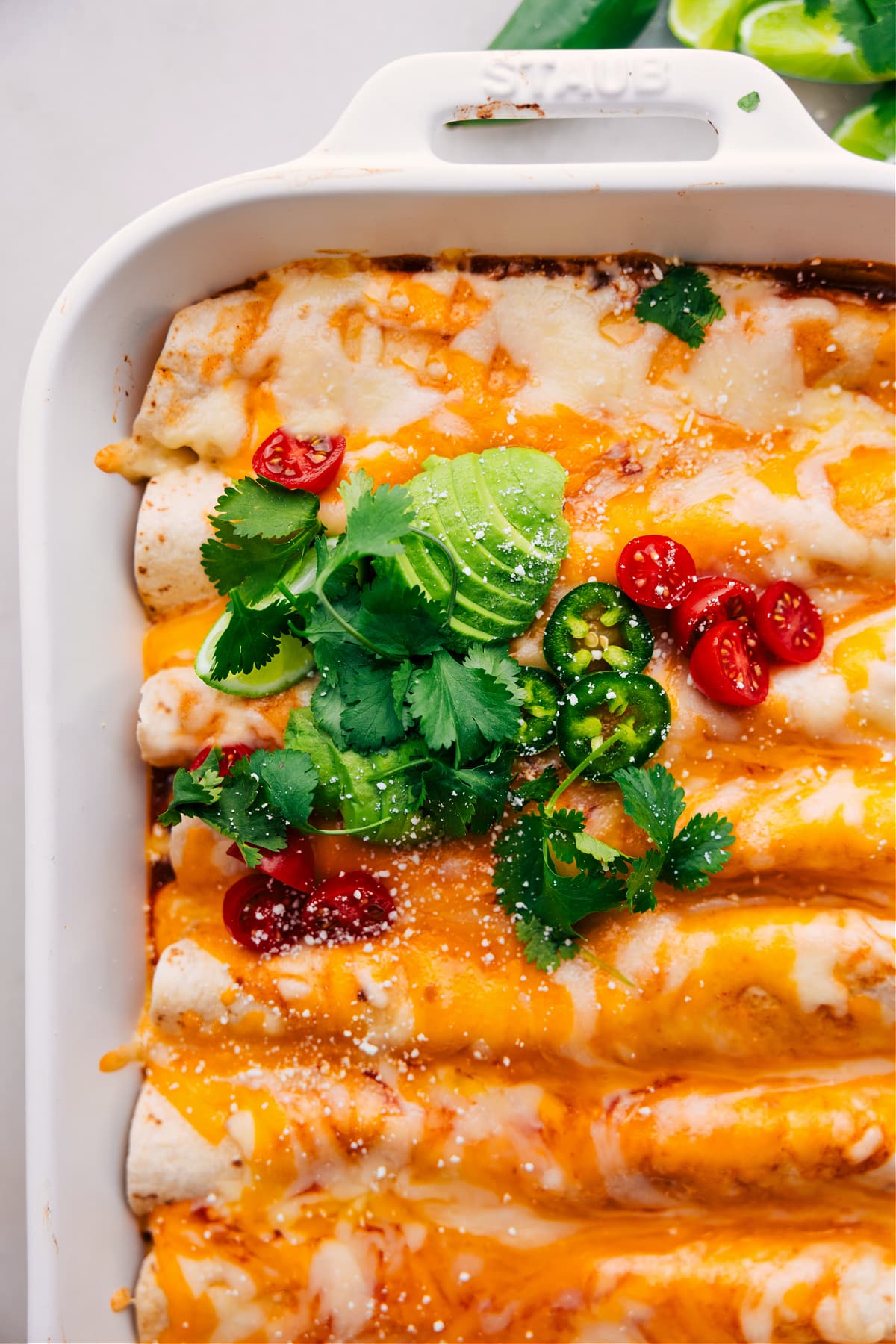 Delicious Vegetarian Enchiladas With Avocado and Cilantro Vegetarian Enchiladas fresh out of the oven, loaded with avocado, tomatoes, jalapeño, and cilantro.