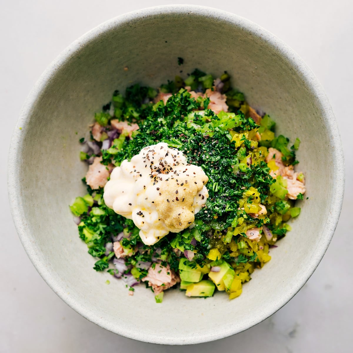 How To Make Avocado Tuna Salad The mayo, mustard, and seasonings are added on top of the mixture.