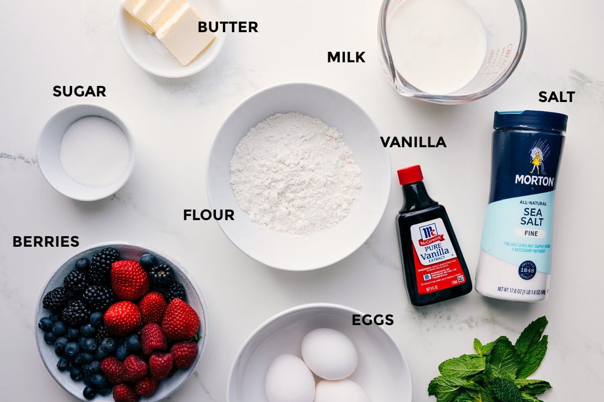 Ingredients In Dutch Baby All the ingredients for this recipe prepped and ready for easy assembly, including butter, milk, salt, vanilla, flour, sugar, berries, and eggs.