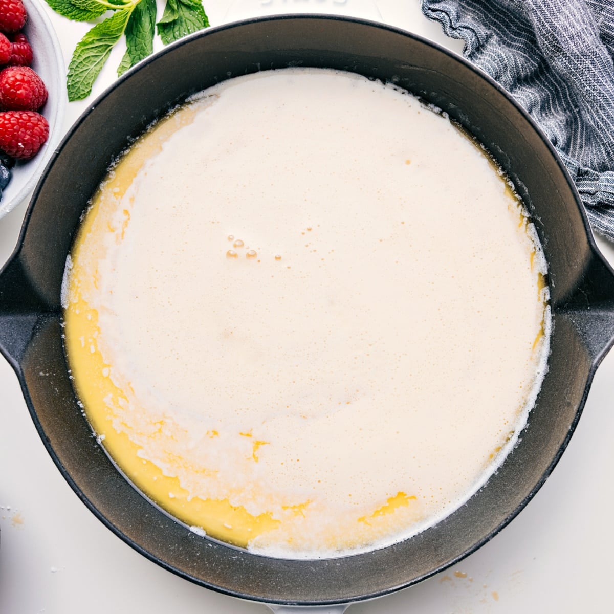 How To Make A Dutch Baby The dutch baby batter poured into a heated and buttered skillet to be baked.