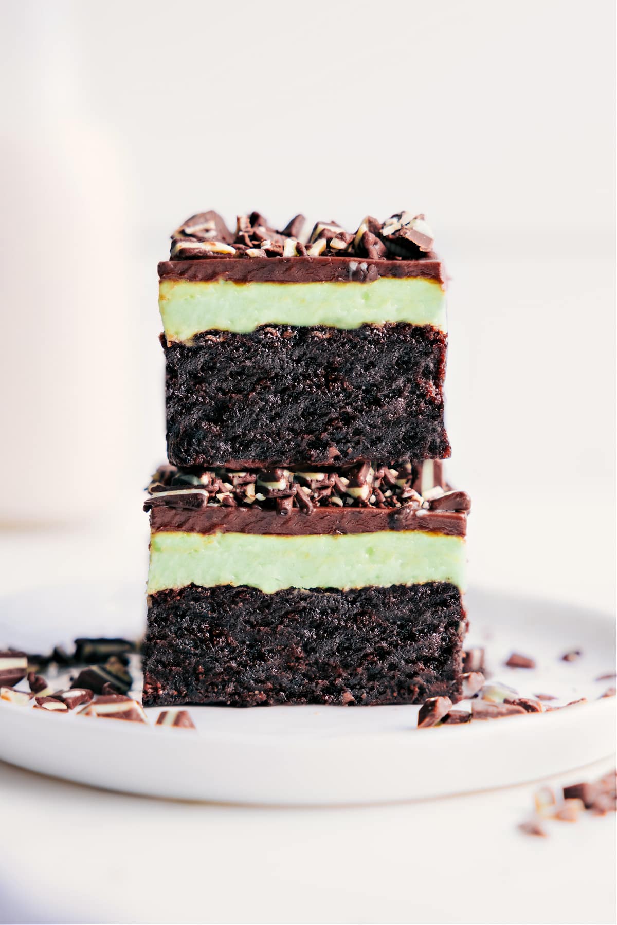 Irresistible Mint Brownies With Mint Frosting And Chocolate Ganache On Top Mint Brownies stacked on top of each other.
