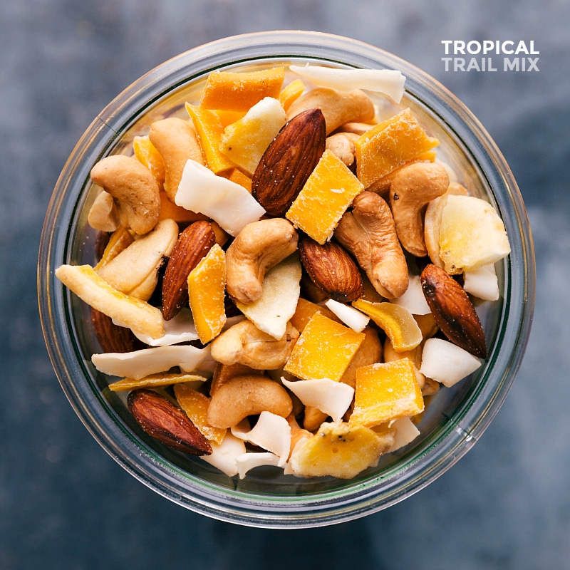 Healthy Tropical Trail Mix in Glass Jar Delicious and healthy tropical trail mix full of nuts, dried fruits, and coconut, showcased in a glass jar.